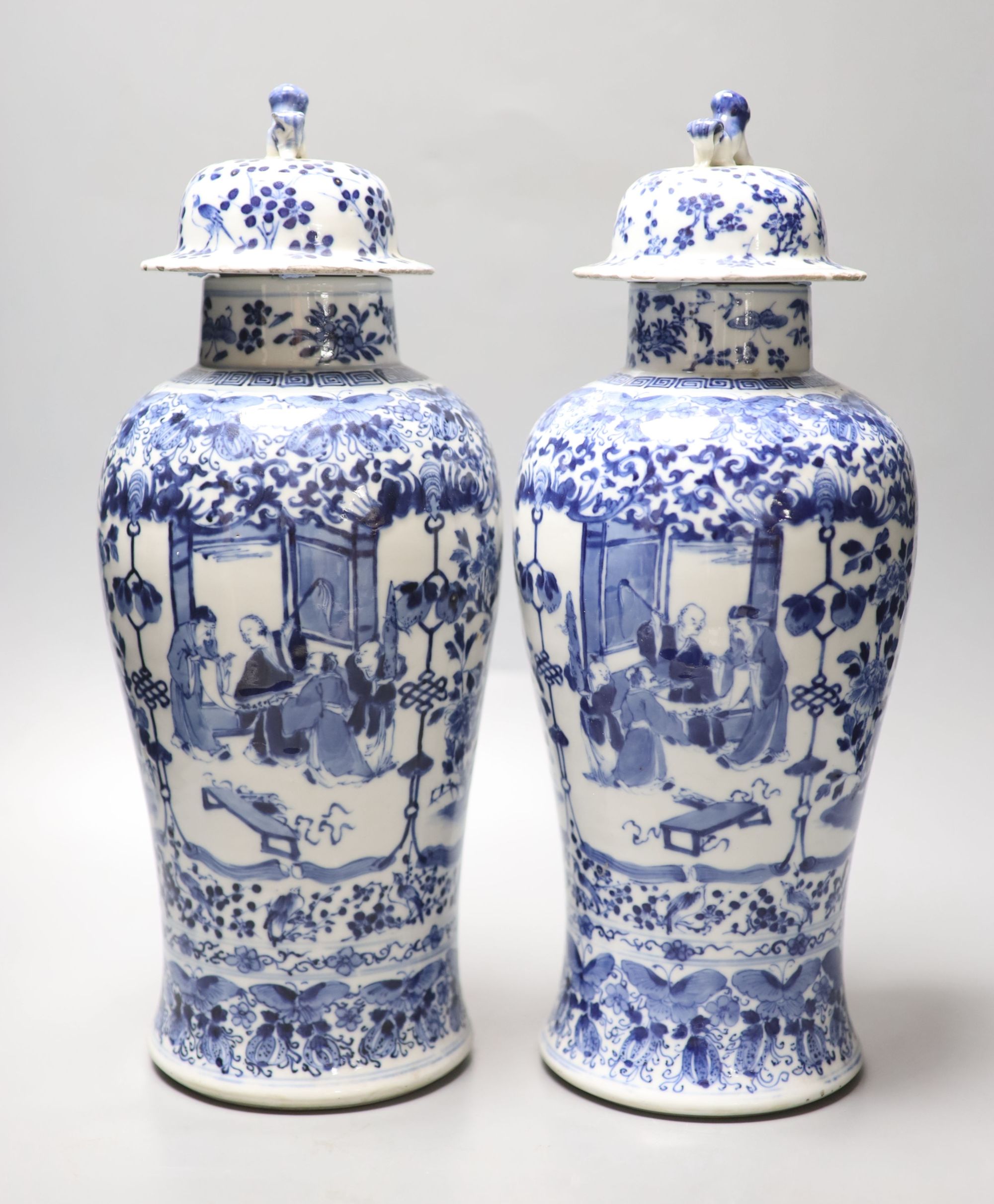 A pair of Chinese blue and white baluster vases and covers, Kangxi marks, late 19th century, 39.5cm high